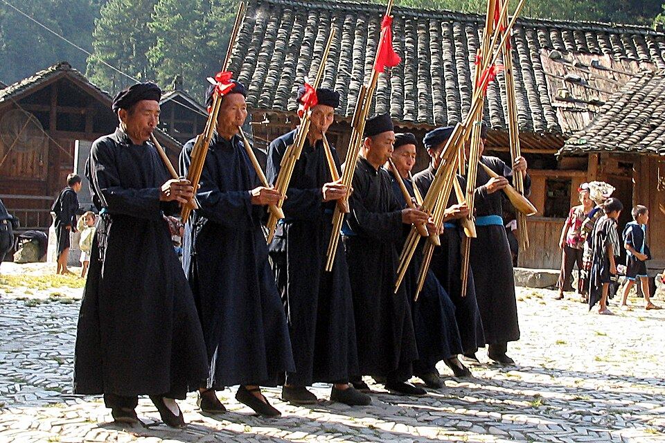 Hmong musicians performing on traditional free-reed instruments in Upper Lang De